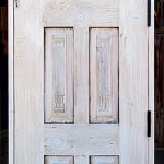 Door with antique carved panels