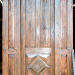 Custom front door made with antique door and salvaged lumber