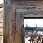 Iron L-strapping on antique wood mirror
