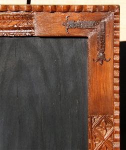 carved mirror with L-strapping detail