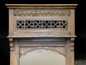 Top detail on one of two elaborately carved mirrors