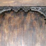 Antique carved panels on custom home bar