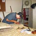 hand carved vanity being carved in wood shop
