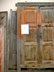 antique cabinet doors used to make entry with inset carving