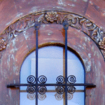 Detail of inset carving on arched door with transom