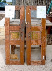 Antique cabinet doors used to make wooden shutters with carved panels