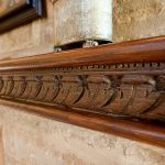 Detail of inset antique carved panel in fireplace mantel