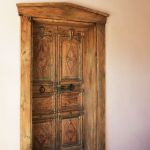 Carved door in arched surround