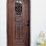 Installation photo of arched door with grilled peep