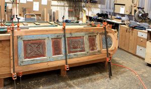 New door being made of antique cabinet door and salvaged lumber