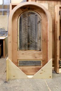 arched wine cellar door in wood shop