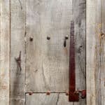 Tin patching and clavos on rustic front entry
