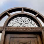 Arched door with transom carving detail
