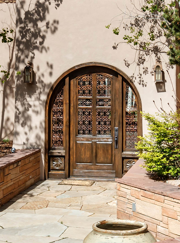 Custom arched door with antique panels and grillwork