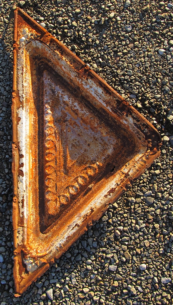 Salvaged tin used to edge gate