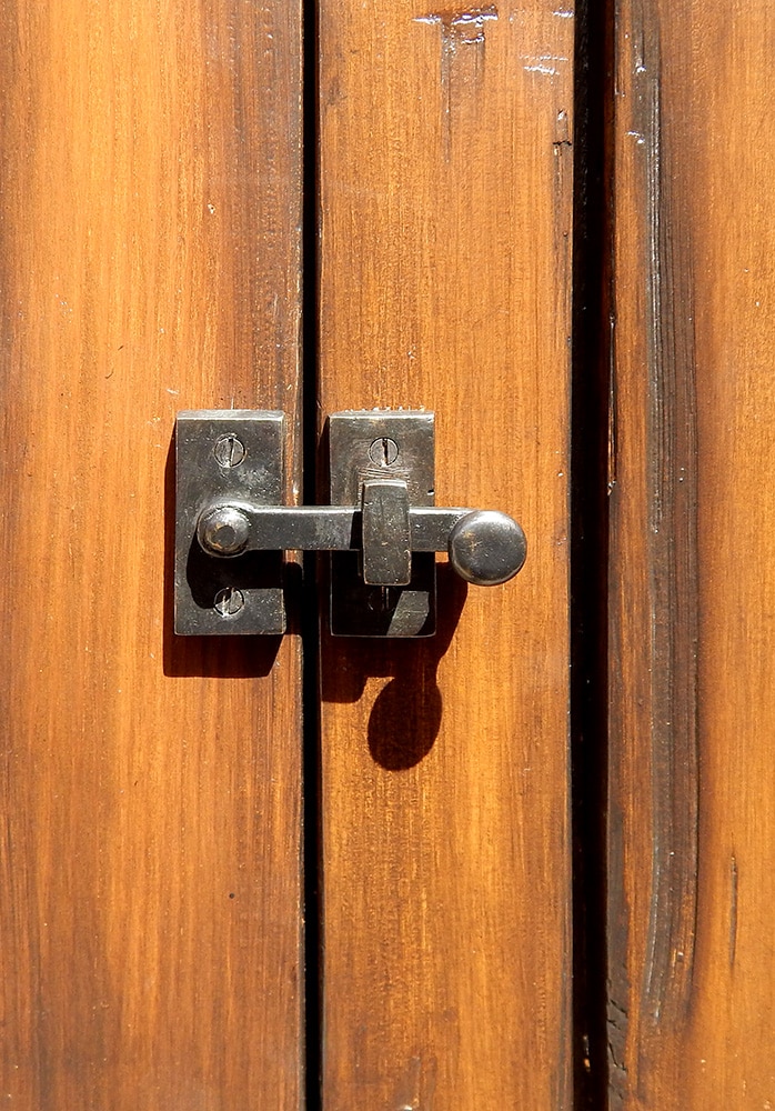 arched front entry with rotating latch on shutter