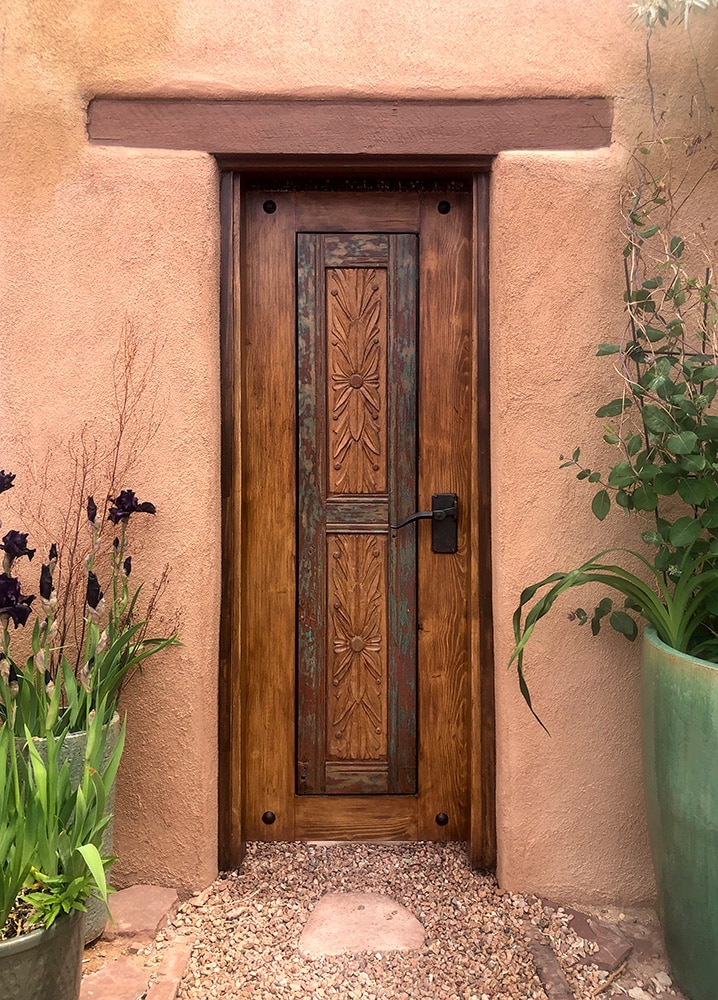 Entry gate with carved panels